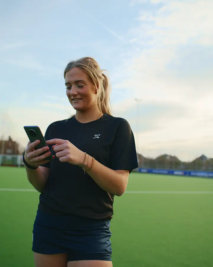 Player checks her score in the app