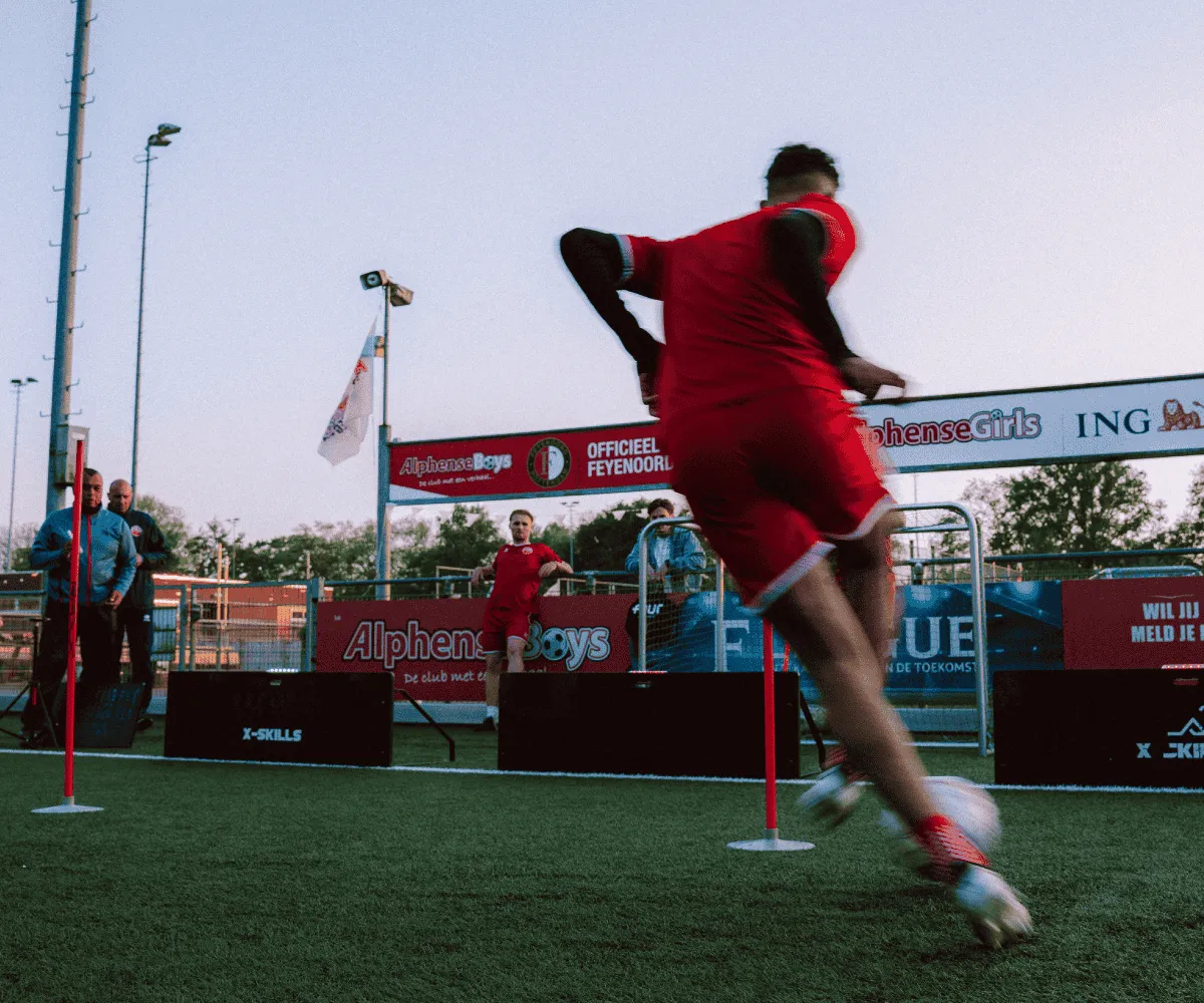 Footballer playing a challenge along the Beams